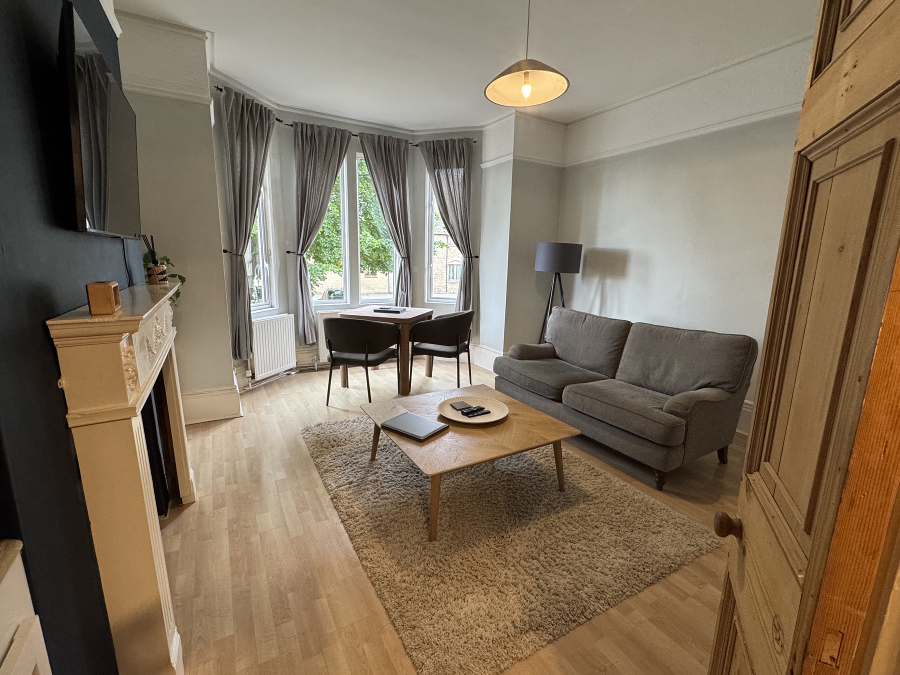 Dining table for two beside the bay window with garden views
